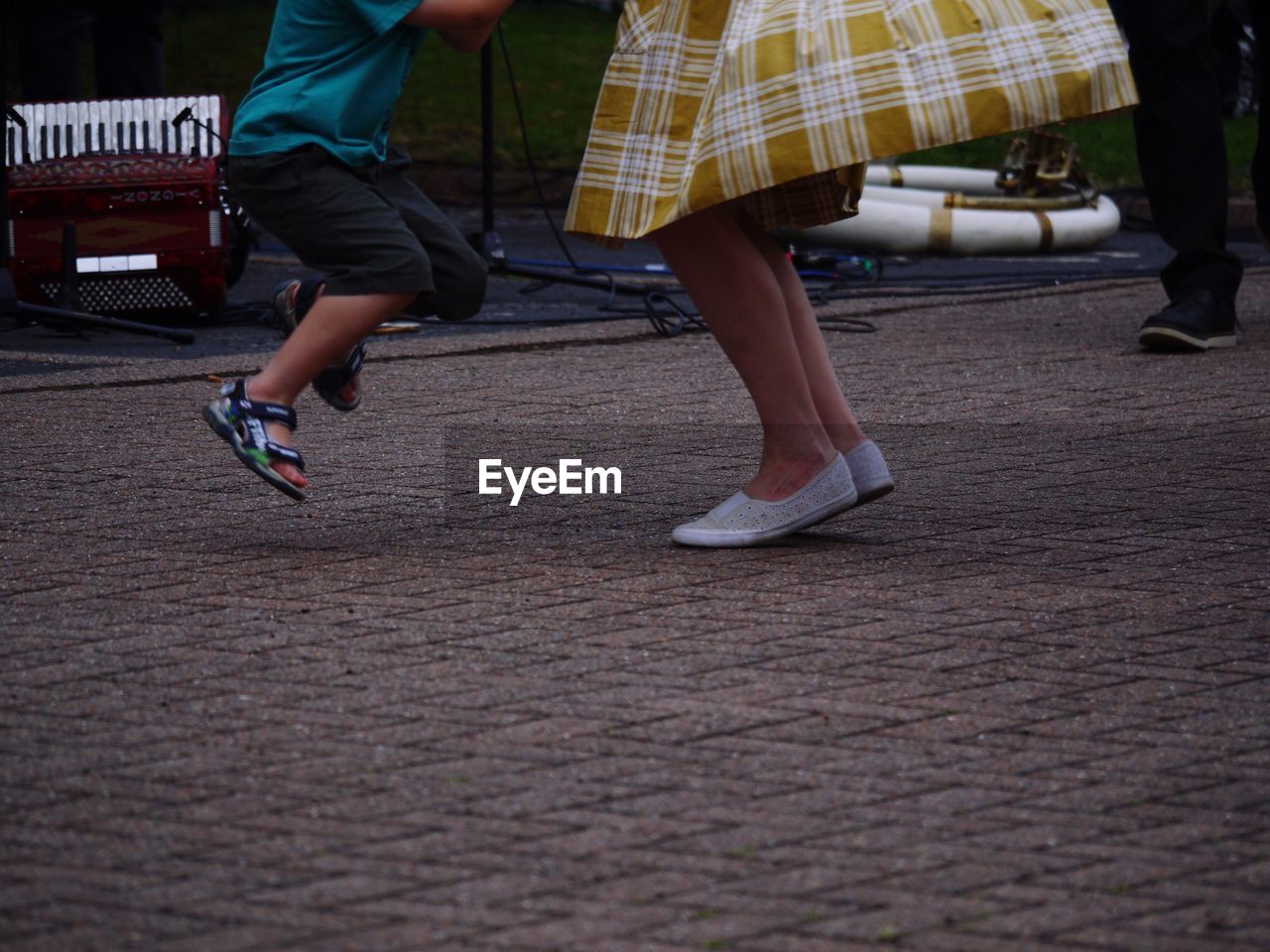 LOW SECTION OF MAN AND WOMAN WALKING ON STREET