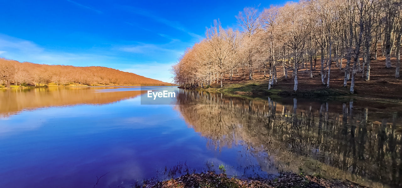 reflection, water, nature, autumn, sky, scenics - nature, tree, beauty in nature, plant, landscape, river, morning, tranquility, tranquil scene, no people, body of water, blue, environment, land, wilderness, mountain, reservoir, outdoors, non-urban scene, cloud, travel destinations, dusk, flower, idyllic, day, leaf, travel