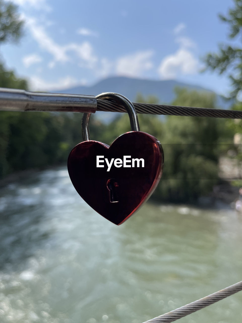 CLOSE-UP OF PADLOCKS ON HEART SHAPE METAL