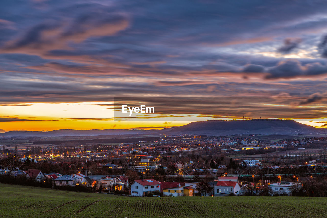 High angle shot of townscape against sky at sunset