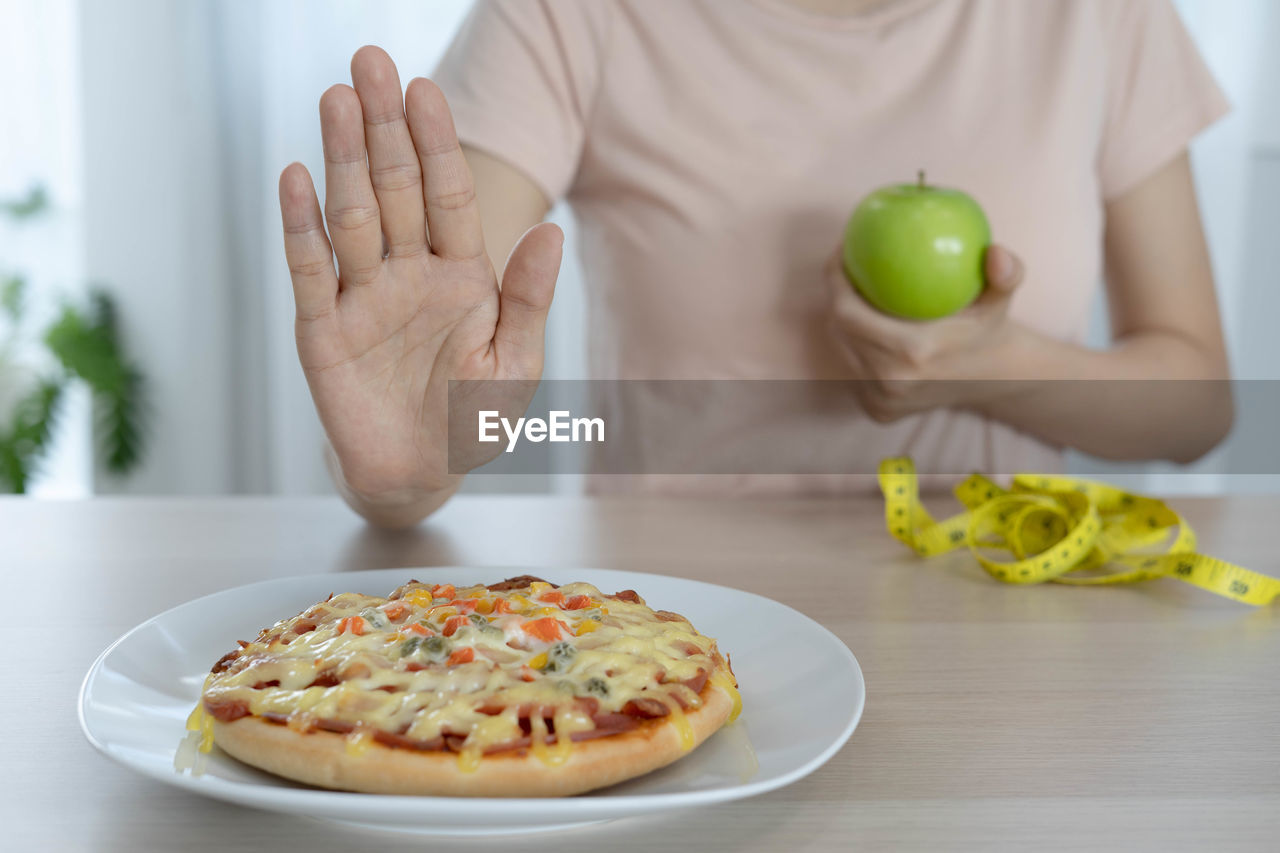 MIDSECTION OF MAN WITH FRUITS