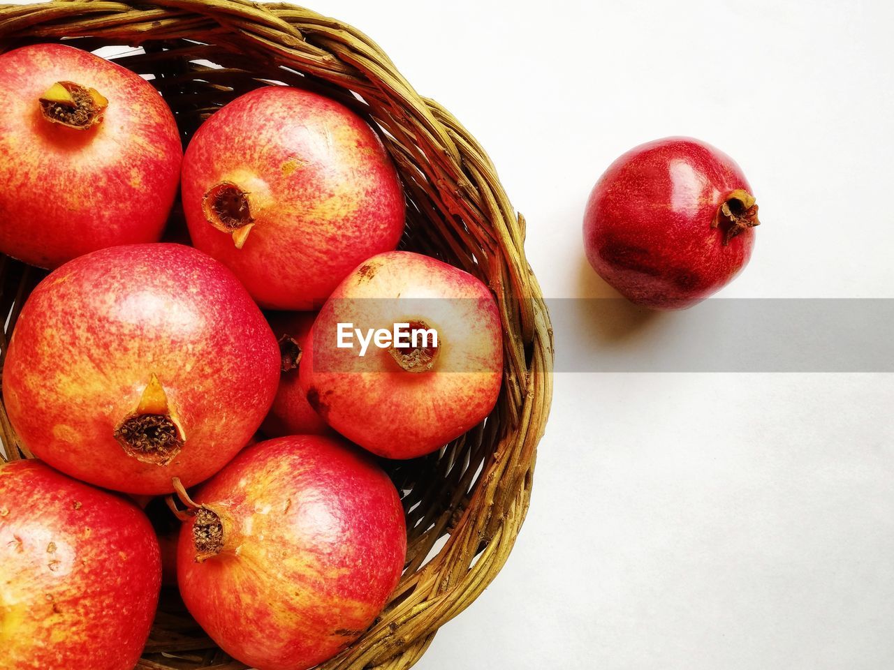 Detail of wicker basket with pomegranates