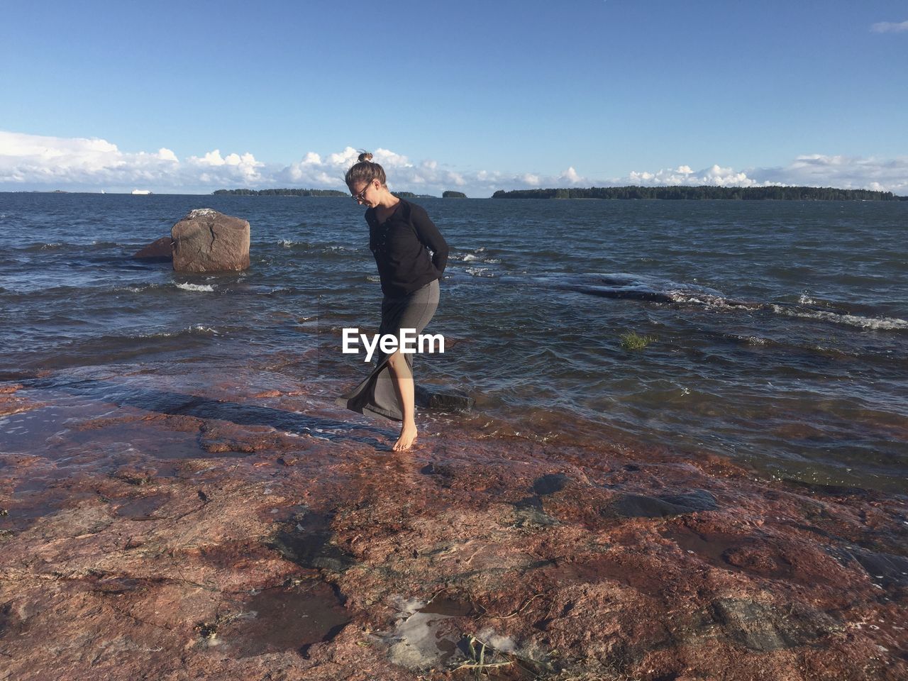 MAN ON BEACH AGAINST SKY