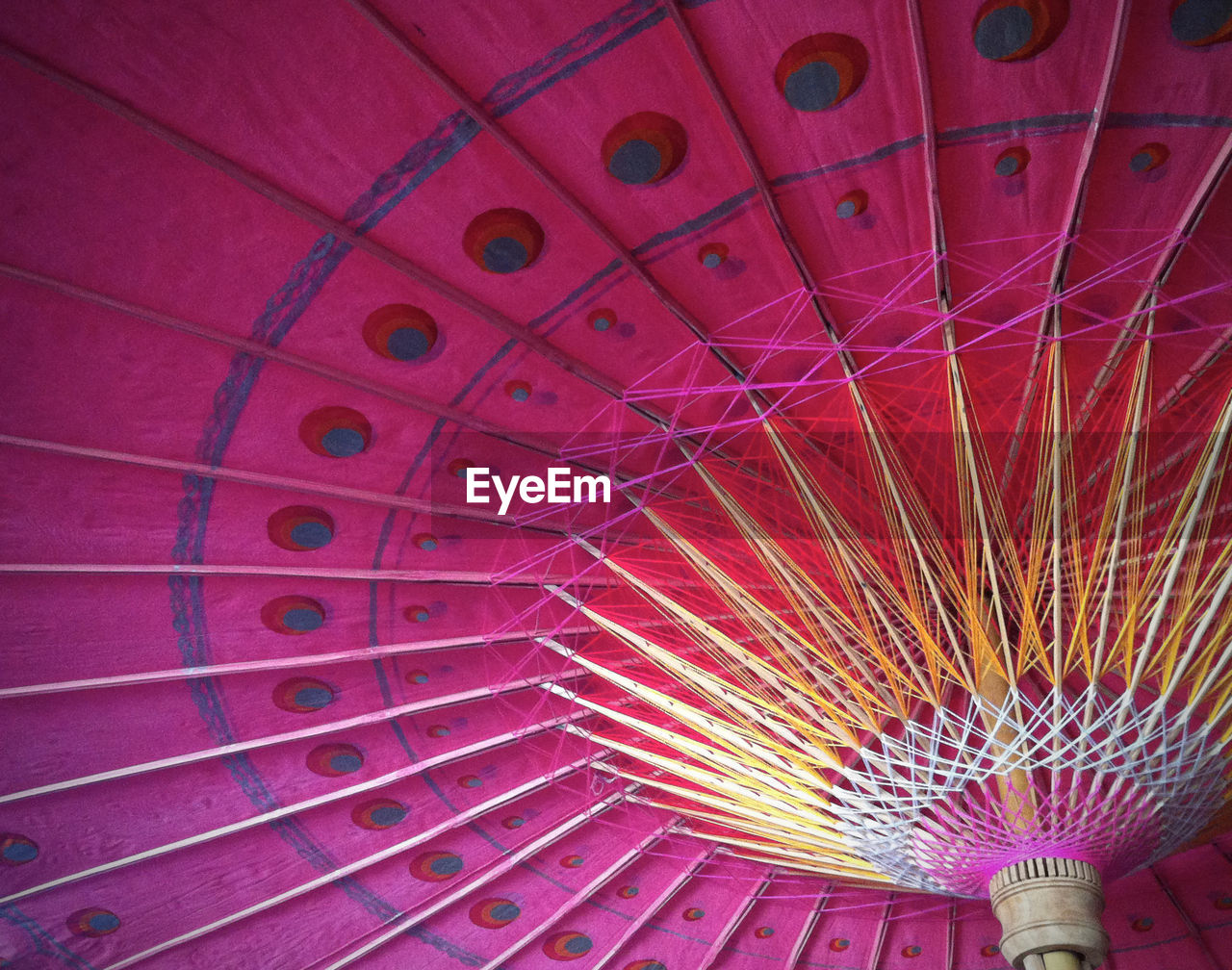 Low angle view of pink traditional umbrella