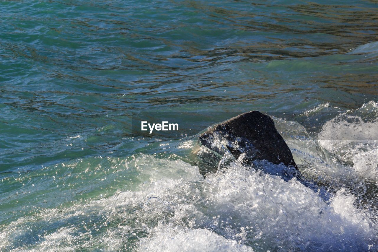 SEA WAVES BREAKING AGAINST SHORE