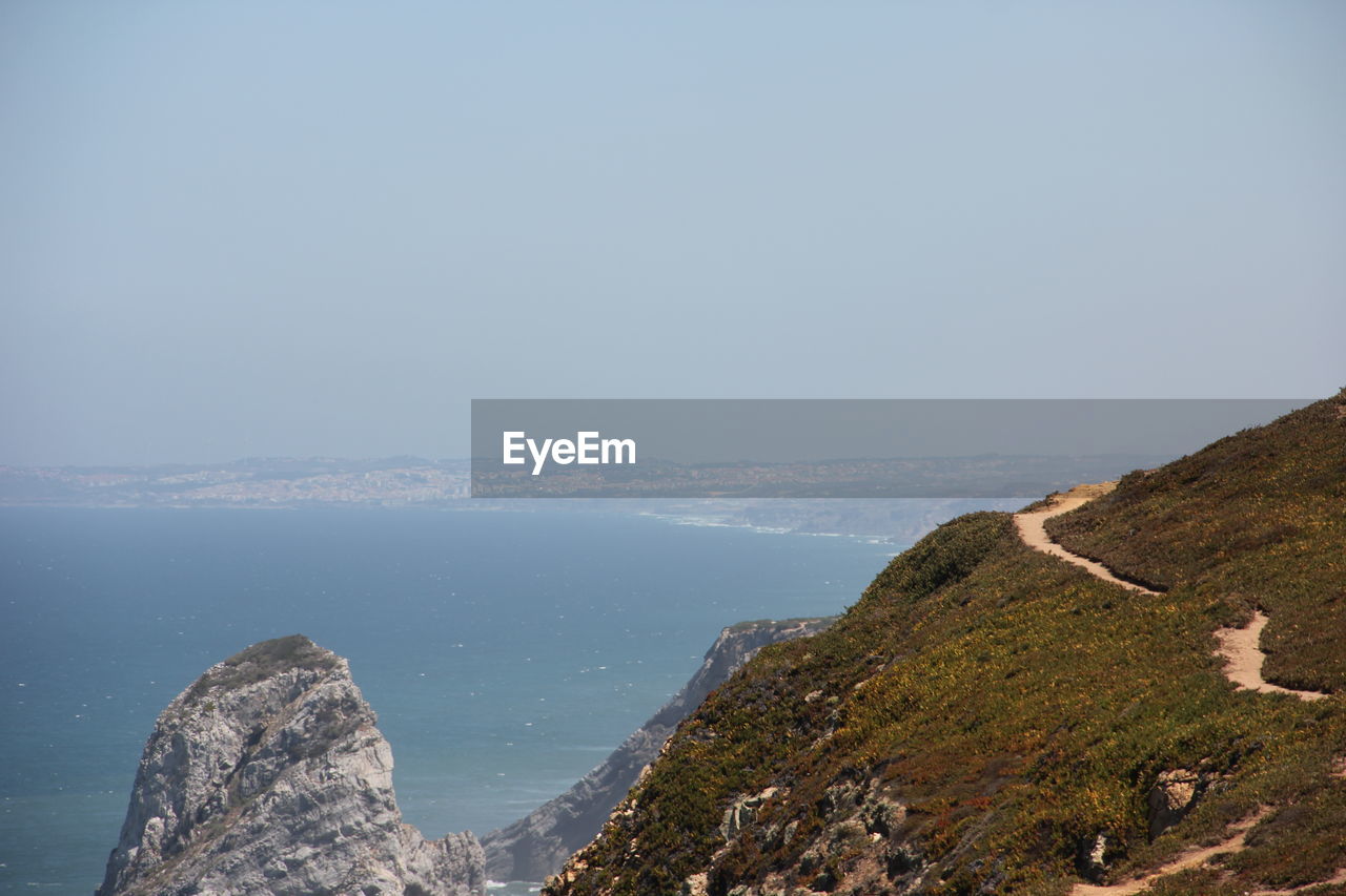 Sea seen from mountain against clear sky