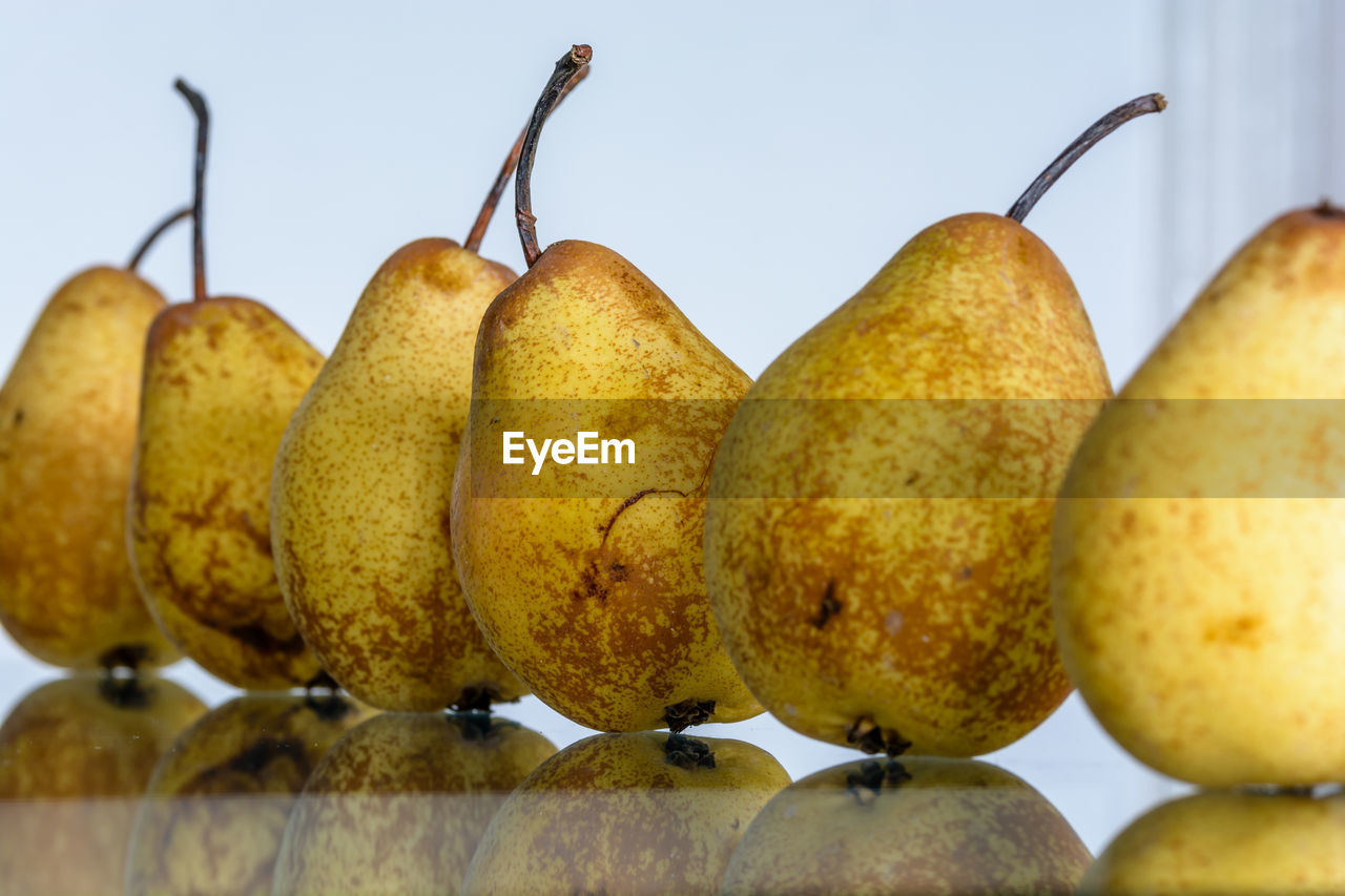 Close-up of pears on glass table