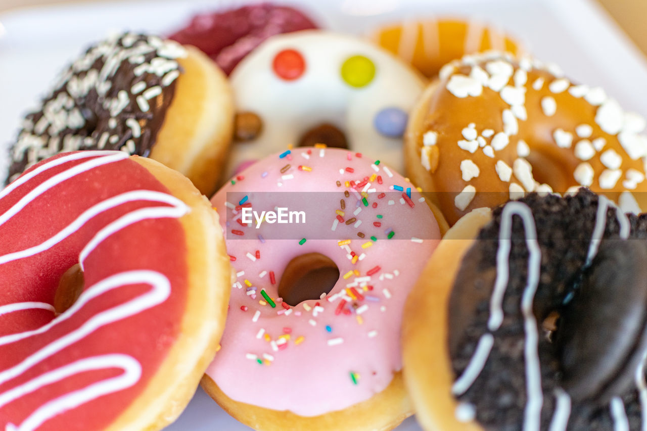 A close image of a selection of tasty donuts with different toppings 