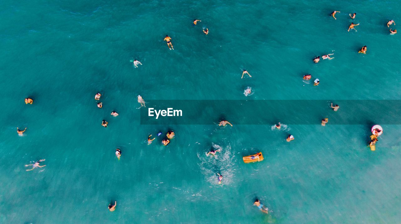 High angle view of people swimming in sea