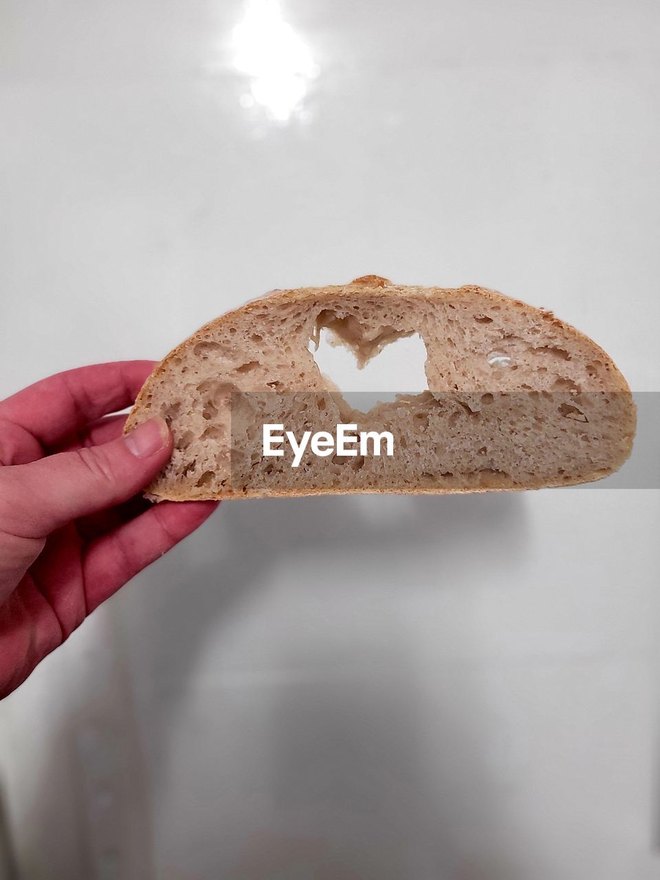 hand, holding, one person, food, food and drink, bread, snack, baked, indoors, close-up, cookie, cookies and crackers, freshness, adult, rye bread, studio shot