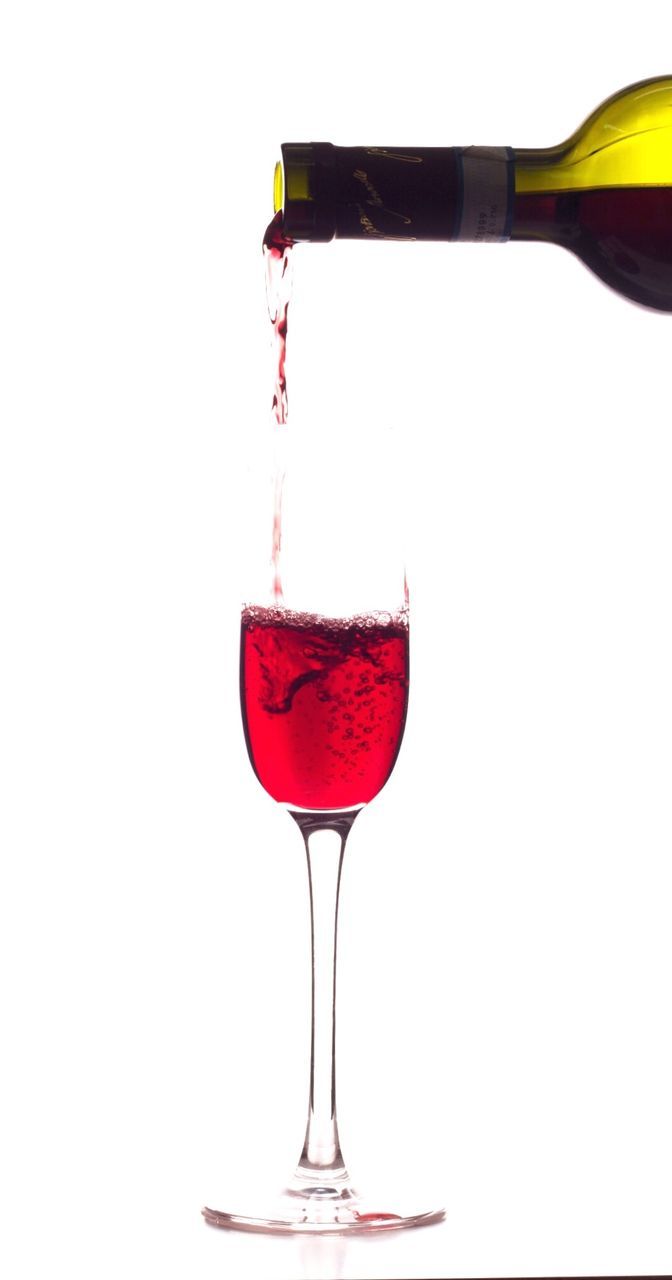Red whine pouring into wine glass