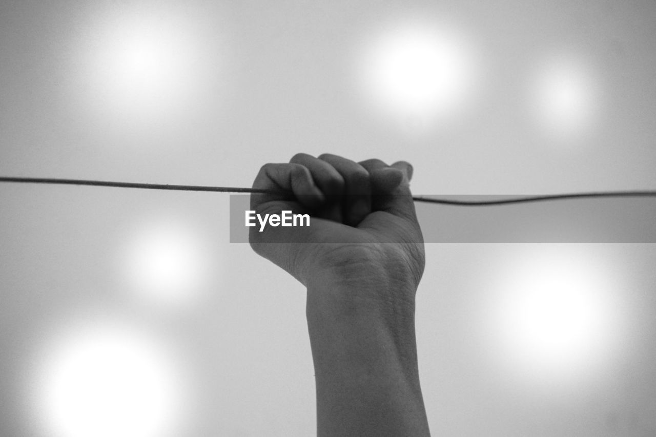 cropped image of person holding cable