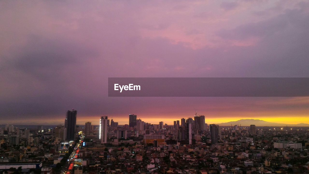 Cityscape against sky during sunset