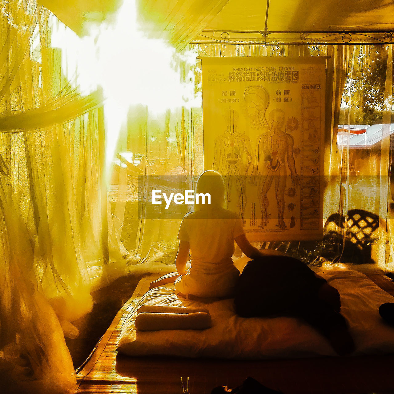 REAR VIEW OF A MAN SITTING ON WOMAN