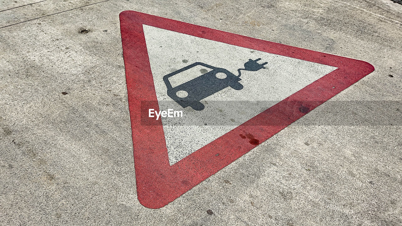 High angle view of electric car parking sign on road