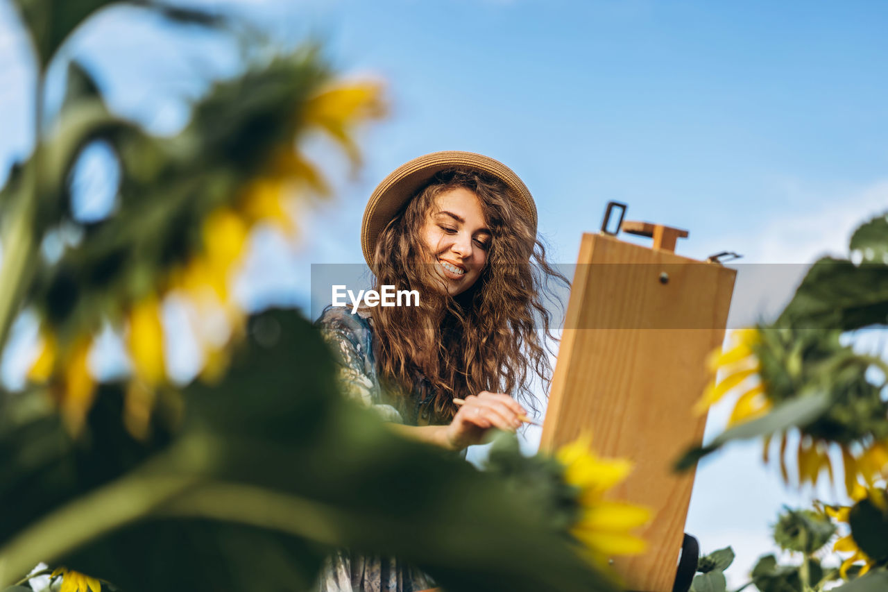 Low angle view of woman against sky