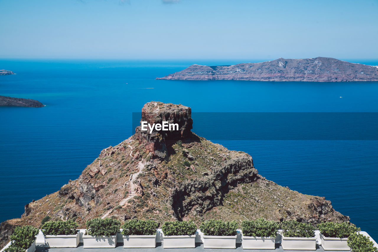 Rock formation against sea at santorini