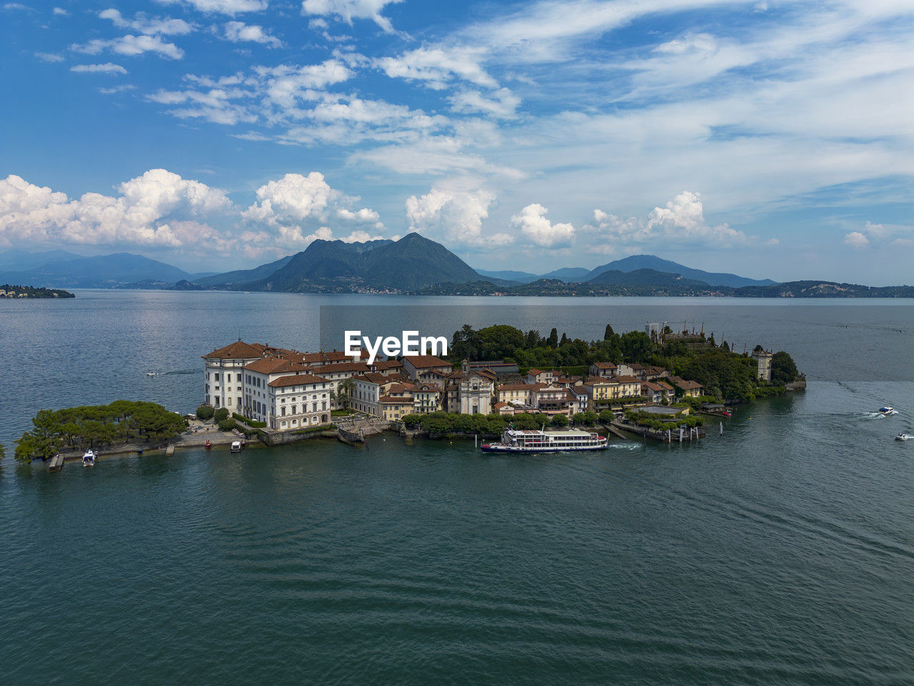 high angle view of townscape by sea against sky