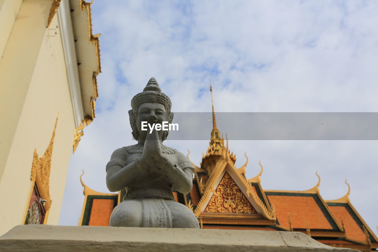 Low angle view of statue against sky