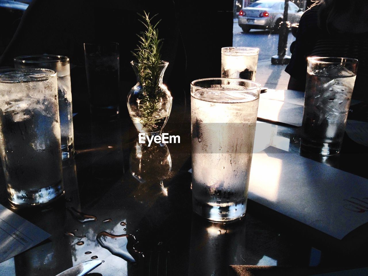 Condensed glasses and vase on table