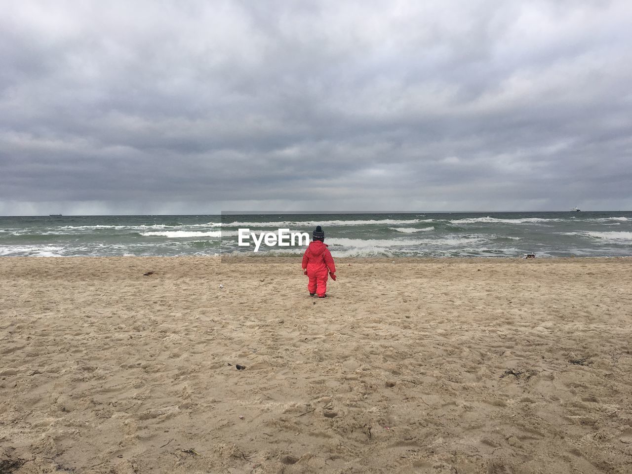 REAR VIEW OF BOY ON BEACH