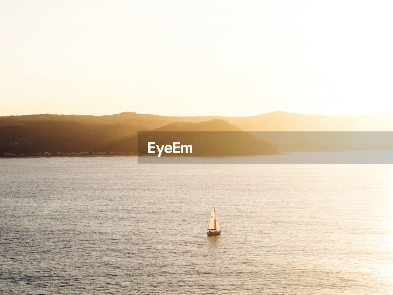 Sailboat in sea against sky