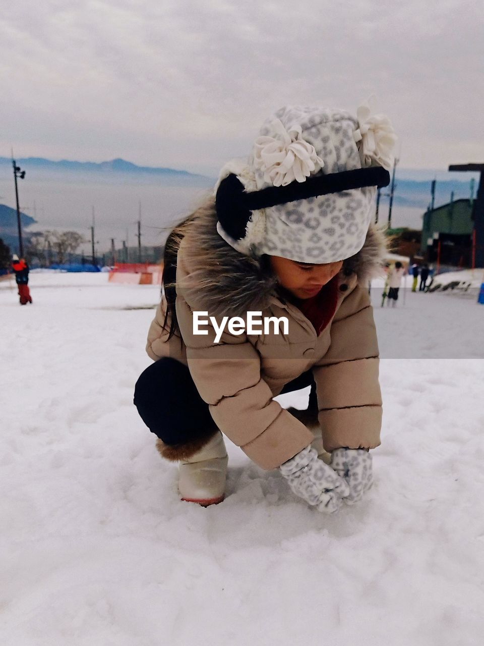 Rear view of woman on snow covered field