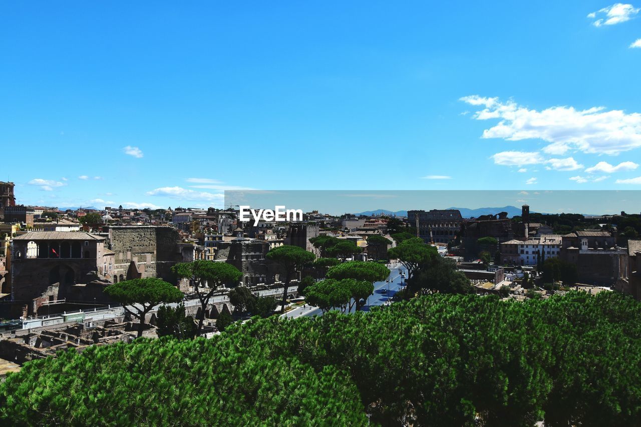 Distant view of coliseum against sky in city