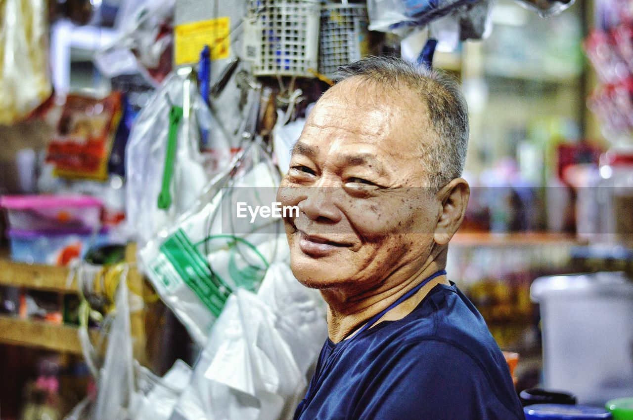 Portrait of smiling senior man in store