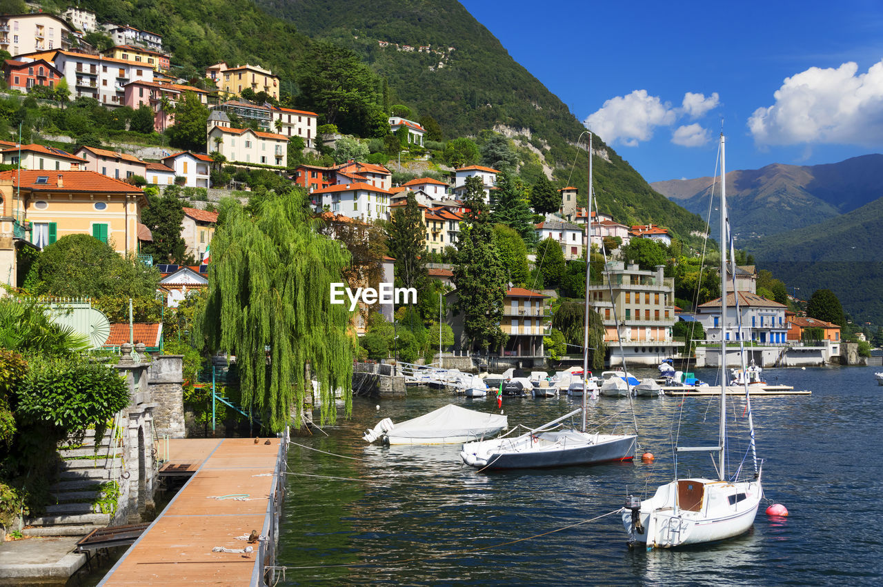 Boats in river against built structures