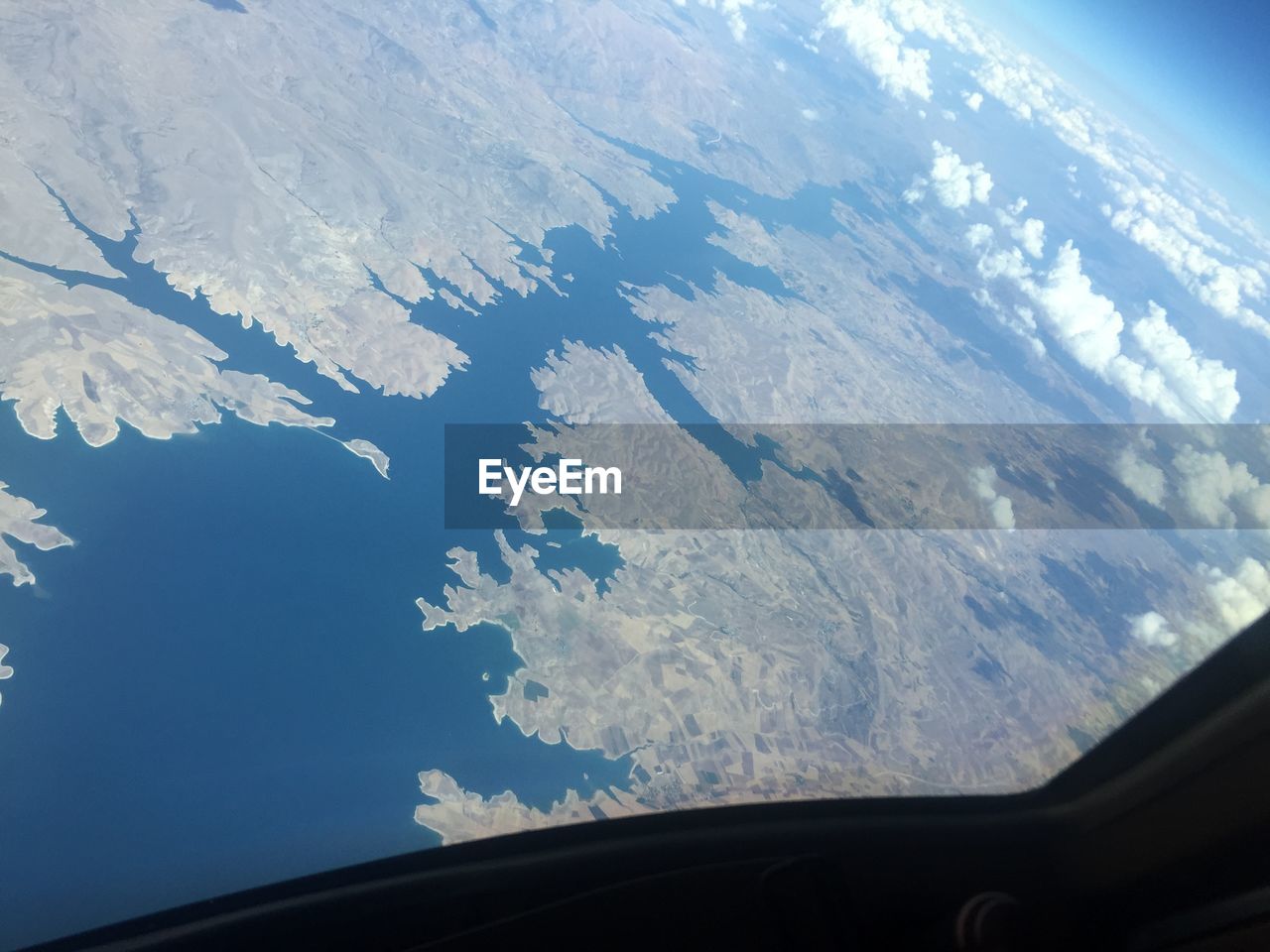 AERIAL VIEW OF MOUNTAINS SEEN THROUGH WINDOW