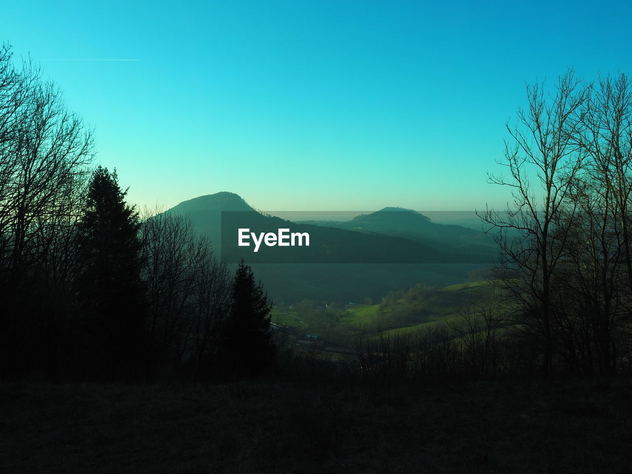 Scenic view of mountains against clear blue sky