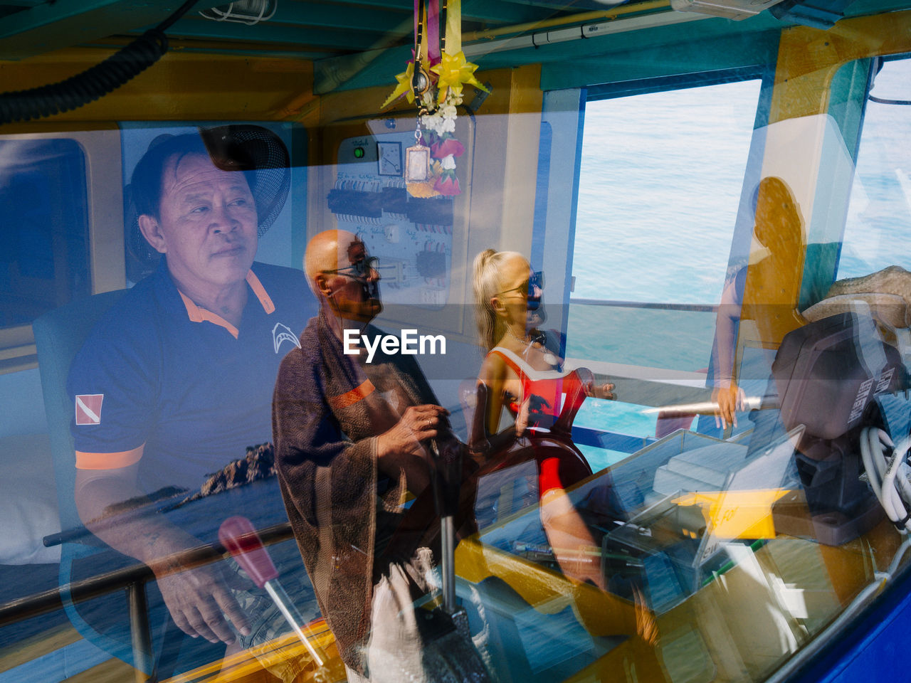 PEOPLE SITTING ON BOAT IN BUILDING