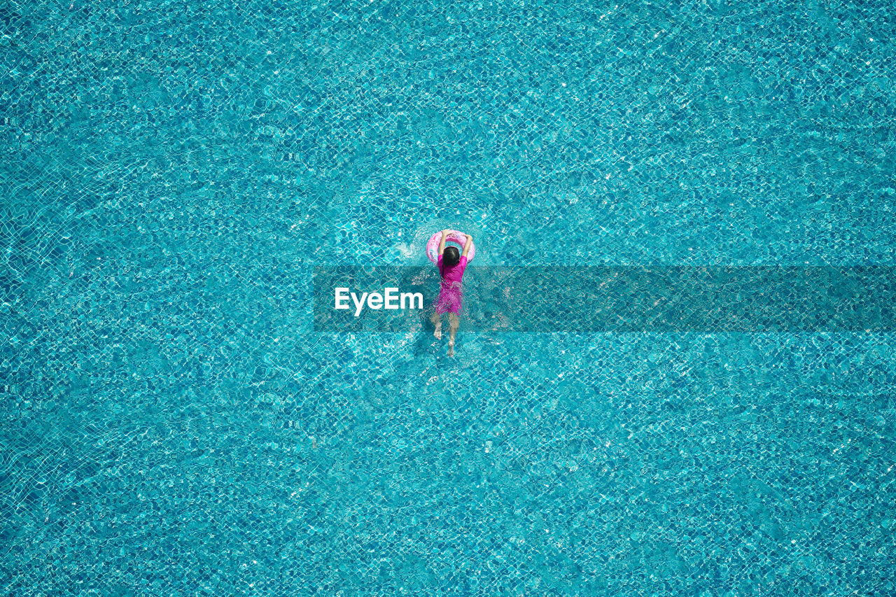 High angle view of child in swimming pool