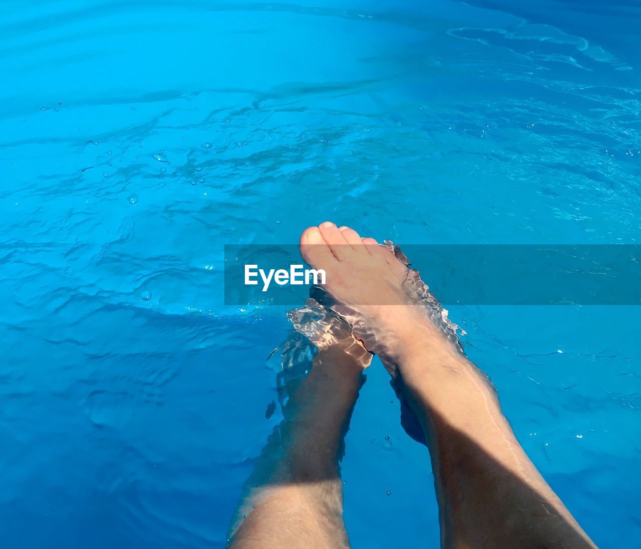 Low section of woman in swimming pool