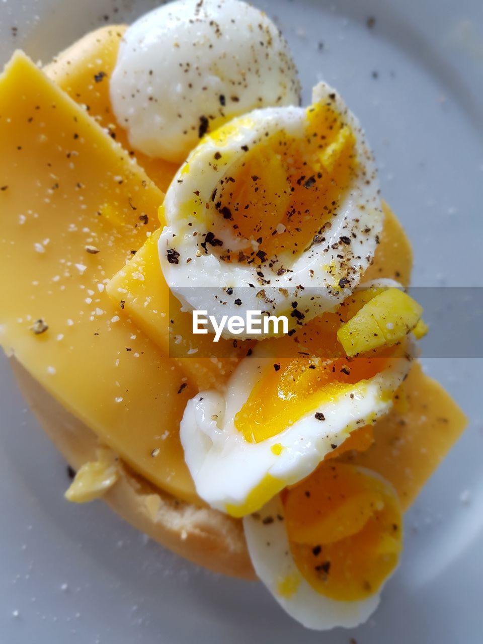 Close-up of egg and cheese in plate on table