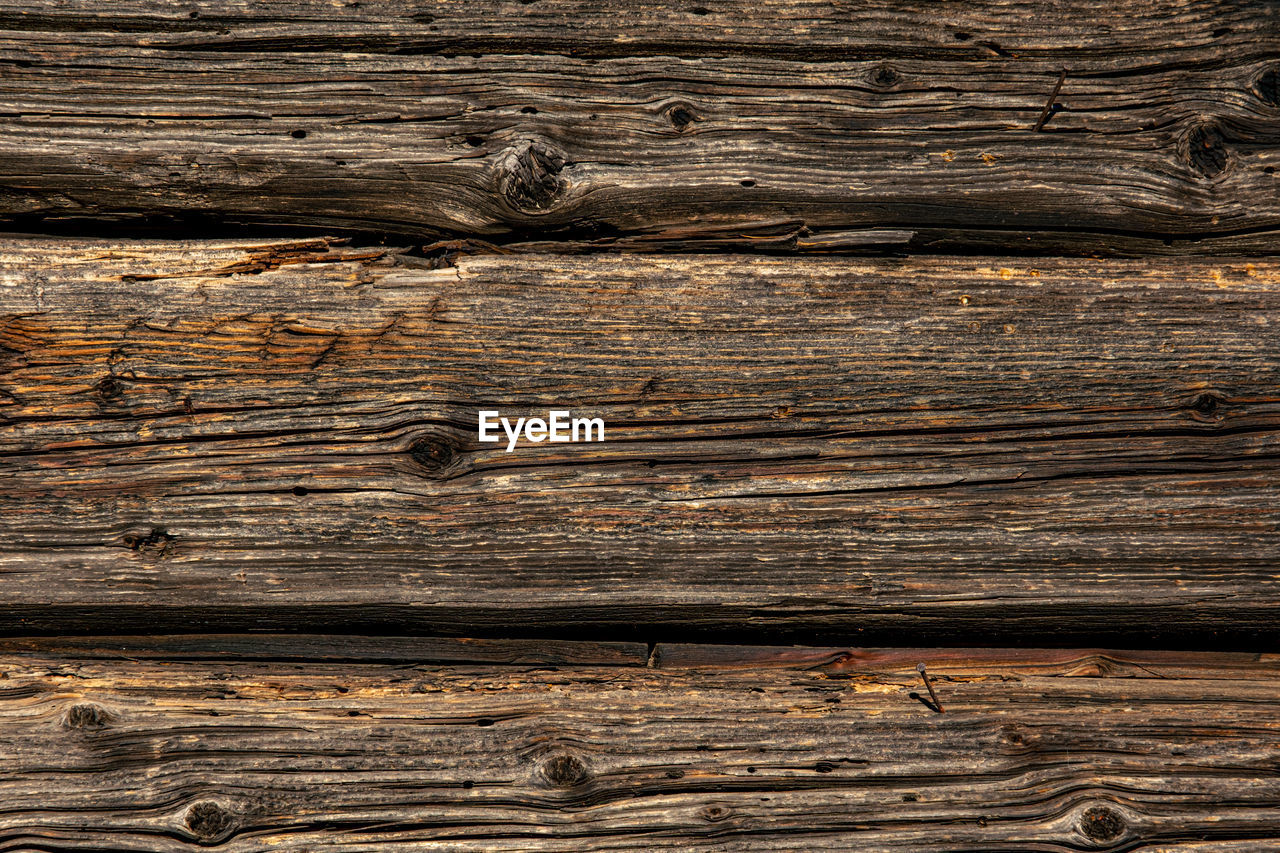 Old rustic wooden planks eaten by caries