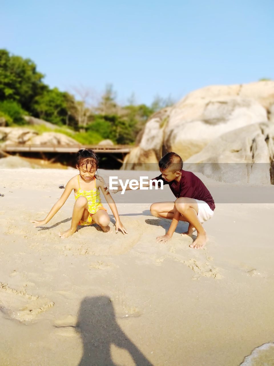 Full length of children standing on land against sky