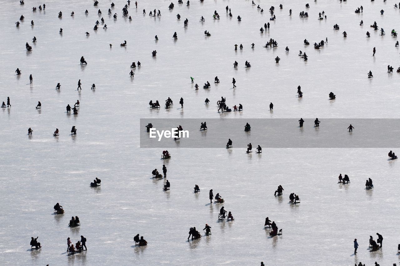 High angle view of people on frozen lake