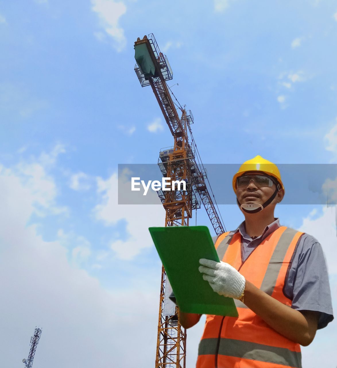 Factory worker with clipboard on the hand