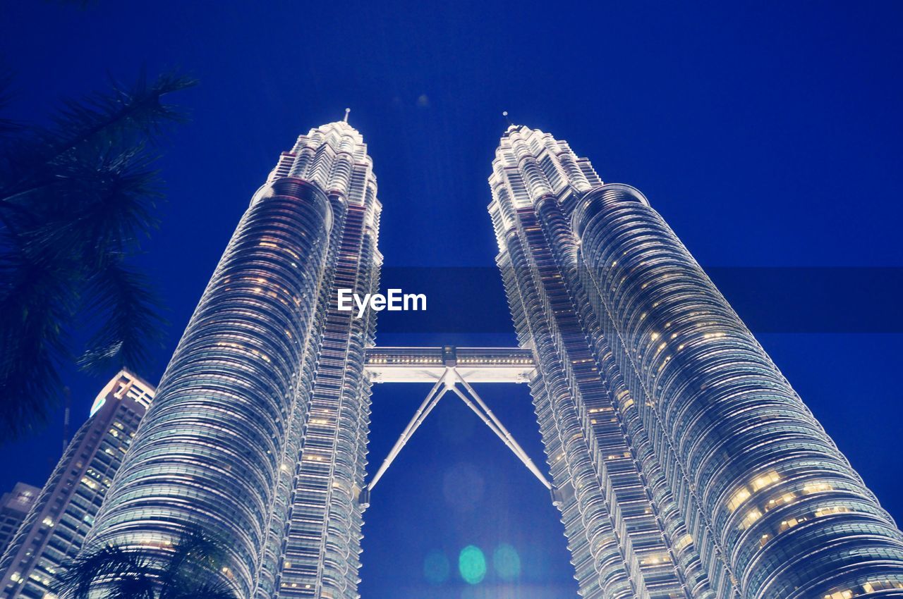 LOW ANGLE VIEW OF ILLUMINATED BUILDING AGAINST BLUE SKY