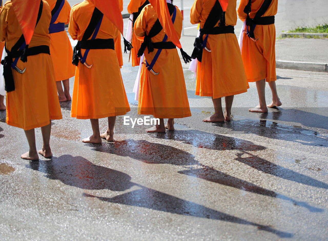 Low section of men wearing traditional clothing during festival