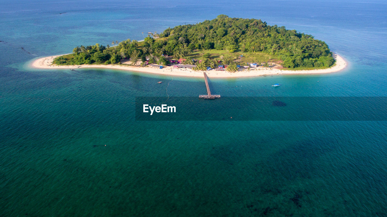 Aerial view of tropical rusukan besar island with wooden jetty and sandy beach in labuan ftmalaysia.