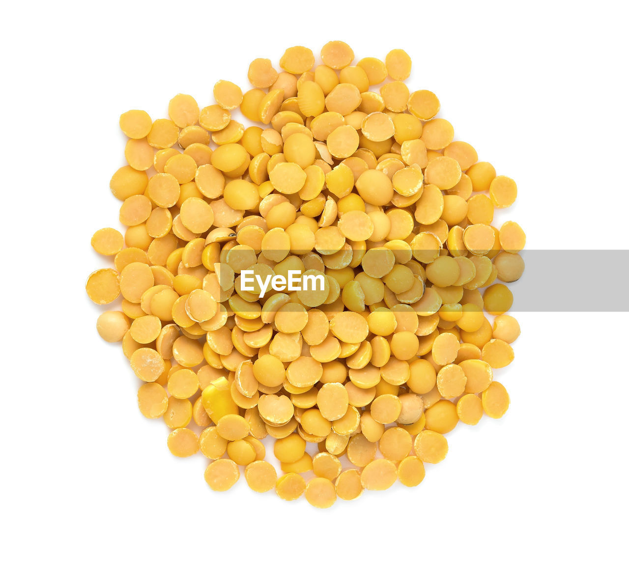 Yellow lentils over white background