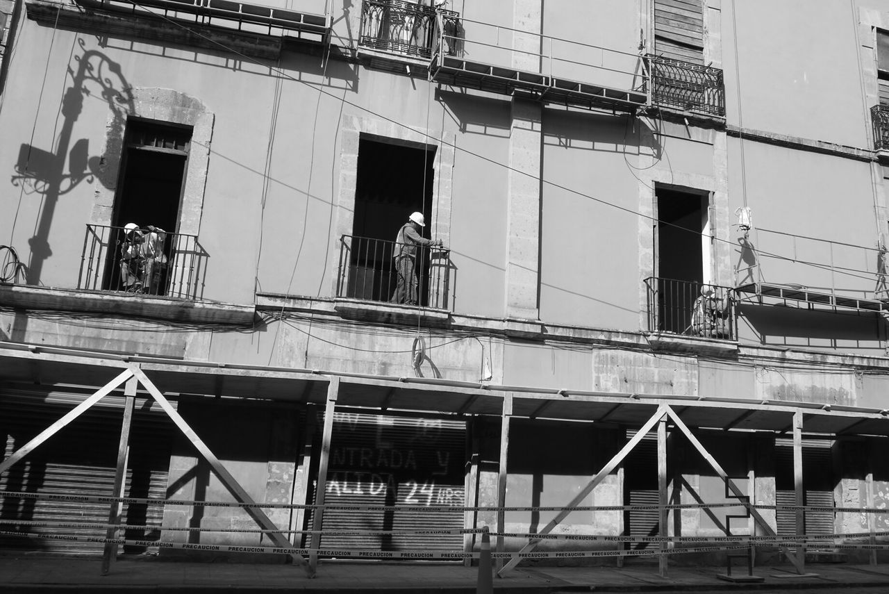 Construction workers on balconies