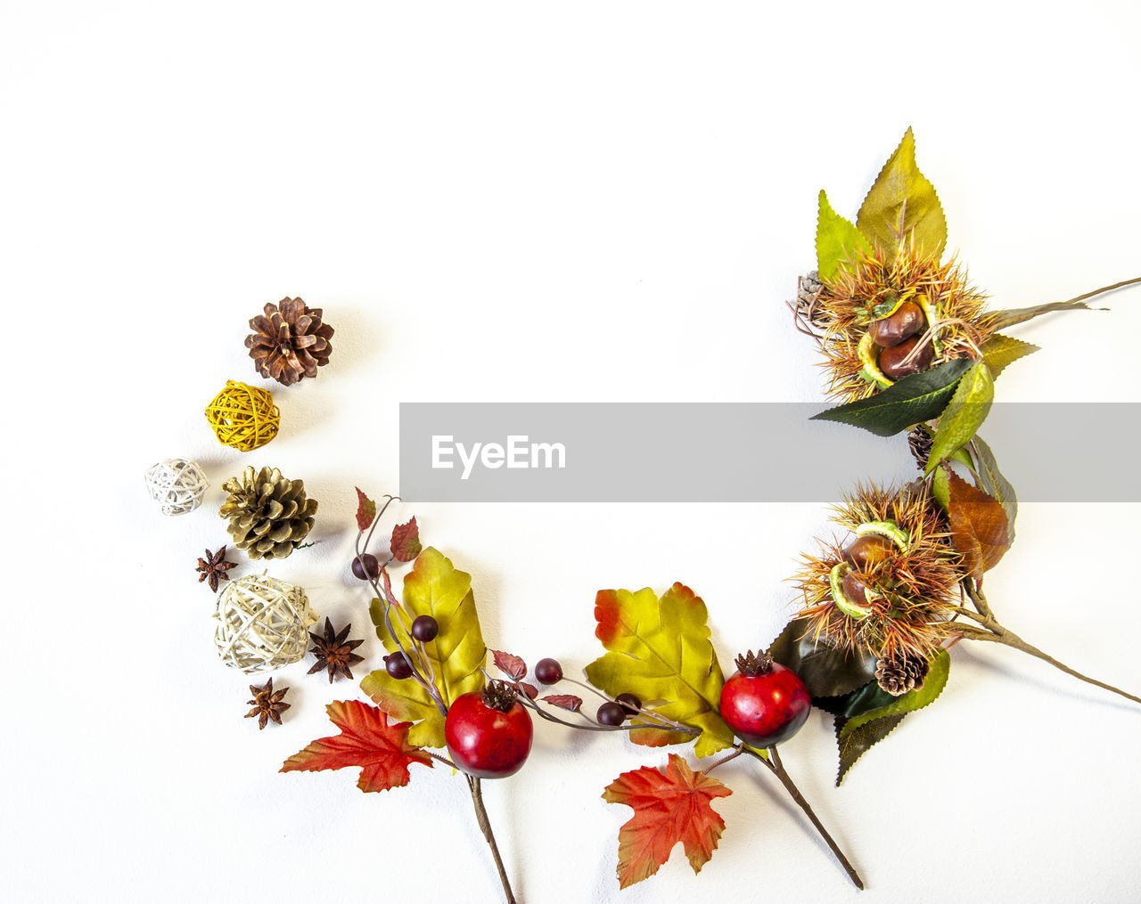 Autumn leaves and christmas decorations on a white background