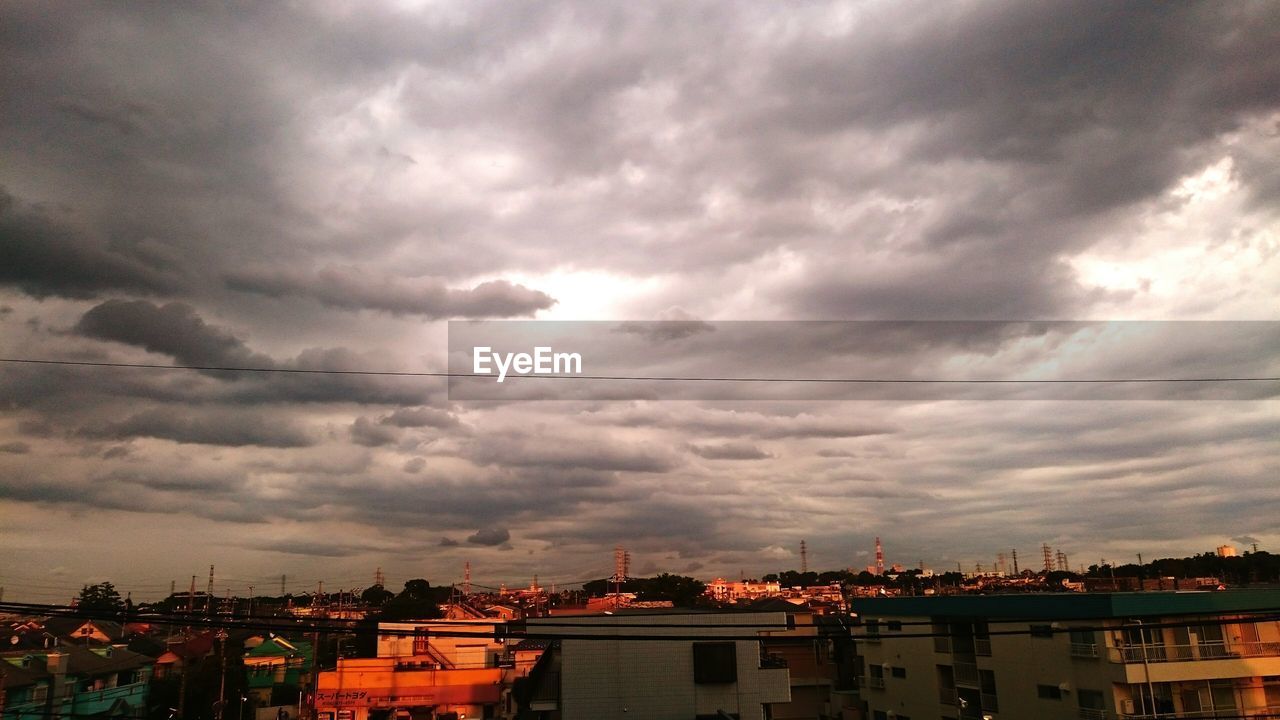 Buildings against cloudy sky