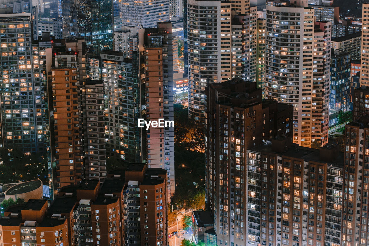 High angle view of illuminated buildings in city at night