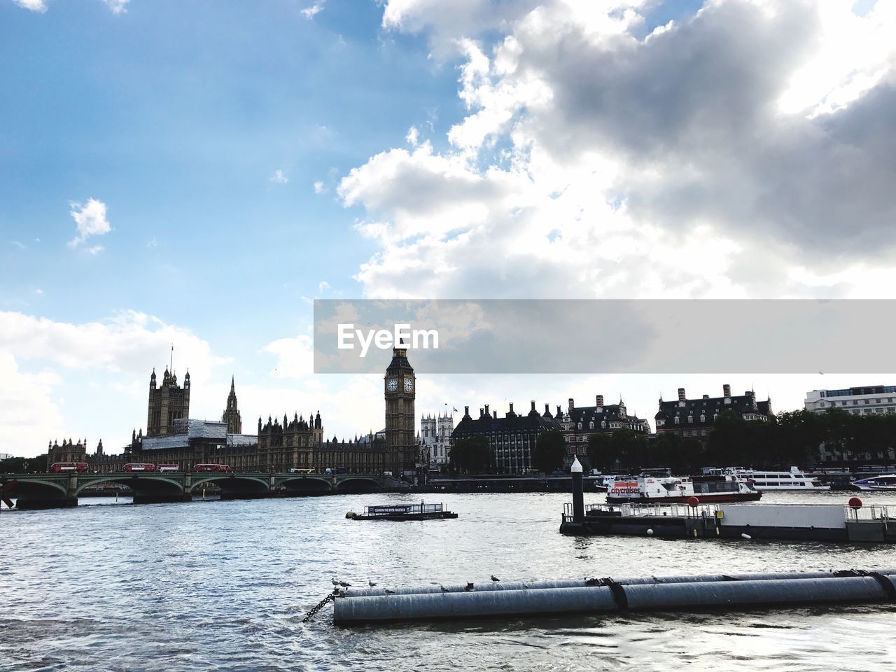 Boats in river with city in background