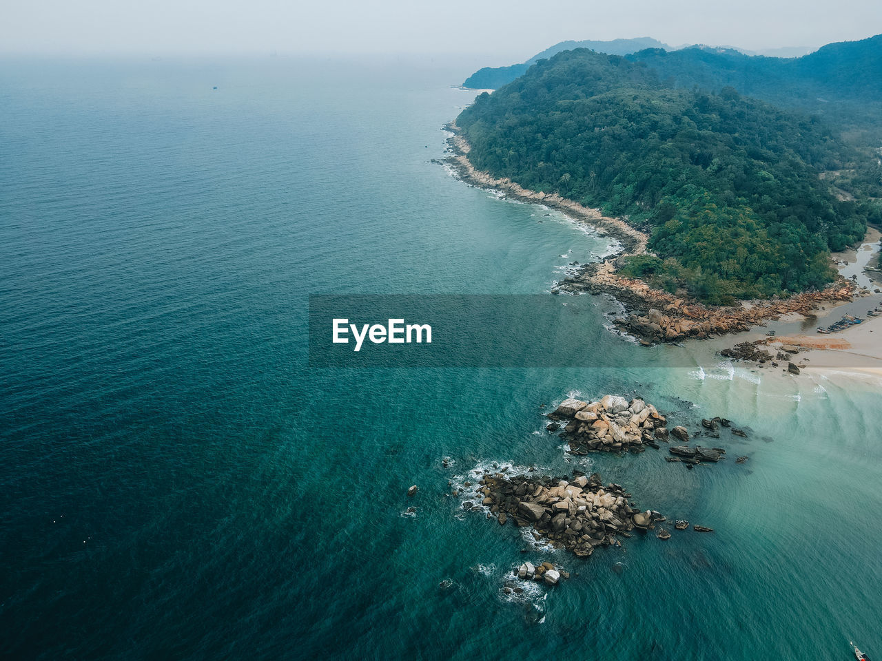 High angle view of sea and stone